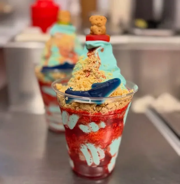 Shark Attack Parfait, blue soft serve with red syrup, cookie crumbs and a gummy shark