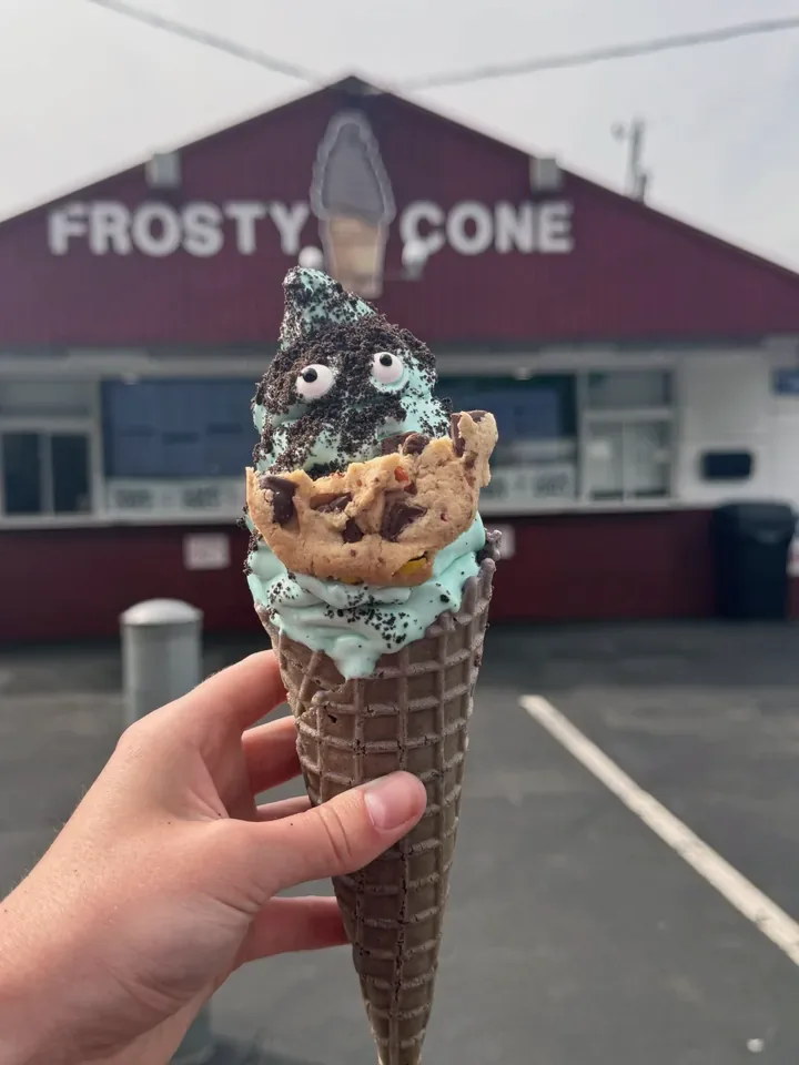 Cookie Monster Cone, mint soft serve with cookie crumbles, candy eyes and a chocolate chip cookie
